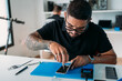 © Manu Padilla/Stocksy - Focused technician screwing in cellphone parts