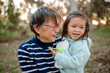 © Erin Brant/Stocksy - Happy grandmother holding granddaughter