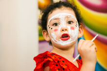 Little Girl In Costume Painting Herself Her Face