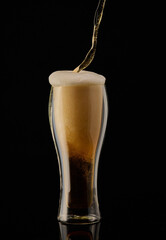 Wall Mural - Vertical shot of a glass of juice on a black background