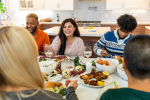 Family Members Laugh During Holiday Meal