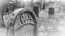 Grayscale Shot Of A Gravestone At The Old Cemetery