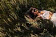 © Liliya Rodnikova/Stocksy - Young woman laying on grass and smiling