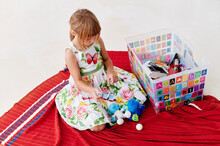 Little Girl Looking Through Her Toy Box