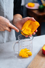Chef Putting Cut Mango Into Glass Jar