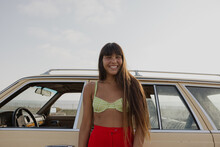 Woman Smiling In Front Of Vintage Car