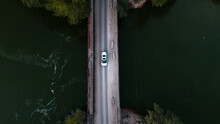 overhead  shot of a brand new car crossing the bridge