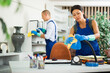 © JackF - Woman and man in uniform, workers from cleaning service, wiping office with cloth and liquid
