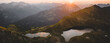 © Akela - from alp to alp/Stocksy - pano shot of mountain lakes at sunset