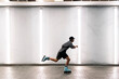© Santi Nuñez/Stocksy - Side view of a young man roller skating in an indoor location