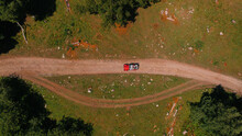 top-view of a red 4x4 Car on the gravel road