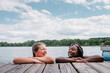 © Gabriel (Gabi) Bucataru/Stocksy - Laughin diverse girls by a lake