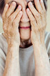 © Sergey Narevskih/Stocksy - Senior woman covering eyes with hands