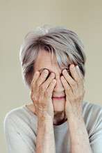 Senior Woman Covering Eyes With Hands