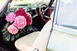 © Angela Lumsden/Stocksy - Flower bouquet in old car