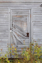 An Old Wooden Door With Herbals Near It