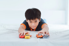 Boy Plays With Toy Cars.