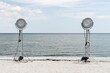 © Andriy Bezuglov/Stocksy - Lighting lamps on light stands at seashore