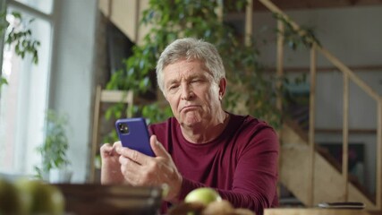  Grandpa is examining a new phone and he is very impressed