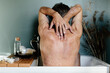 © Sergey Narevskih/Stocksy - Man with skin disease washing in bathtub