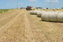 Tractor Moving Hay Bales