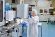 © ALTO IMAGES/Stocksy - Woman operating conveyor at plant