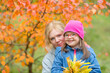 © Ermolaev Alexandr - Portrait Woman and her daughter with special needs  at autumn park. Empty space for text