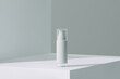 © Marc Tran/Stocksy - white cream cosmetic bottle on acrylic geometric pedestal podium block,