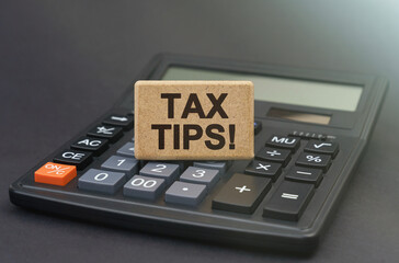 Wall Mural - There is a sign on the calculator that says - Tax Tips