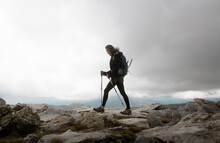 Female Hiker Walking Over Rocks