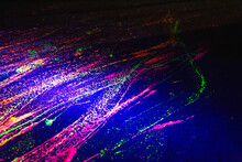 A Skateboarders Marks Of Fluorescent Paint On Street 
