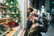 © Daniel Gonzalez/Stocksy - A family shopping for christmas