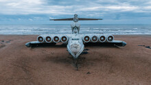 Front View Of A Military Airplane Lost On The Beach