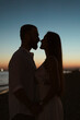 © Mauro Grigollo/Stocksy - Silhouette of a Couple kissing at sunset