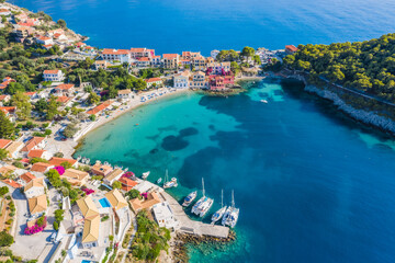 Wall Mural - Assos picturesque fishing village from above, Kefalonia, Greece. Aerial drone view. Sailing boats moored in turquoise bay