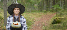 Girl In Witch Costume Holding Pumpkin Lantern, Halloween Concept, Girl In The Forest Playing With Jack Lantern