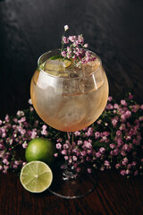 fresh spritz cocktail with lime and ice cube in wineglass