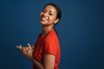 Young black woman wearing t-shirt smiling and looking at camera