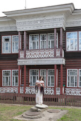 Wall Mural - Vorobyov's old wooden house with ornamental carved windows and balcony in Zasodimsky Street, 14, Vologda city, Russia. Vologda landmark, monument. Vologda sight, view