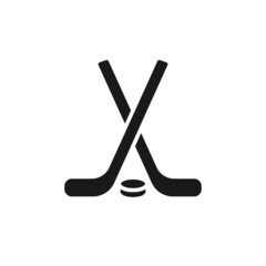 Wall Mural - Isolated black icon of hockey stick and puck on white background. Silhouette of ice hockey icon. Logo flat design. Winter sport equipment.