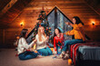 © _KUBE_ - Christmas and new year. A group of young happy women socialize and untangle the lights. Scandinavian style interior