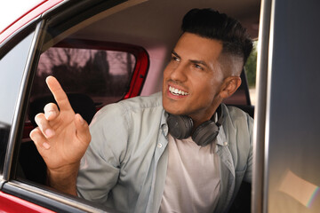 Wall Mural - Man looking out of taxi window outdoors