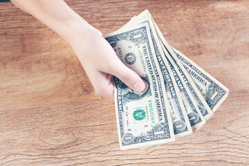 young woman holding dollar bills