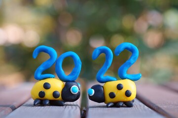 Canvas Print - The number 2022 and two ladybugs made of plasticine. Calendar date. A festive event. New Year's Eve.