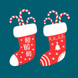 Decorated Christmas stockings with candy canes on a blue background, vector illustration