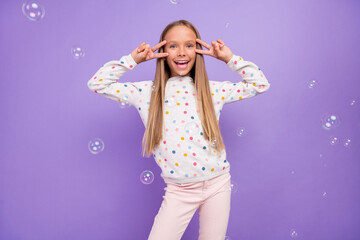 Photo of friendly little lady soap bubble fly show v-sign wear dotted pajama isolated purple color background