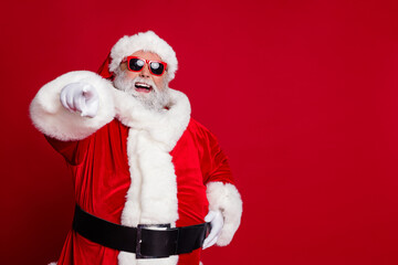 Poster - Portrait of attractive cheerful confident Santa pointing at you copy space select isolated over bright red color background