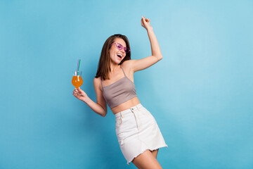 photo of joyful young positive woman hold hands cocktail dance weekend vacation isolated on blue col