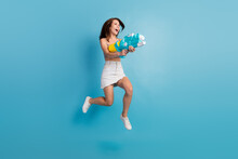 Full Size Profile Side Photo Of Young Girl Happy Positive Smile Play Water Gun Jump Isolated Over Blue Color Background