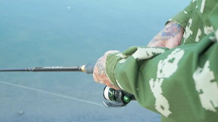 Wall Mural - eldest on bank of the river, a man with a fishing rod fishing, beautiful nature, autumn. An old man rests and loves his hobby. Active healthy lifestyle, outdoor. close up slow motion